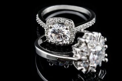 Luxury jewellery. White gold or silver engagement rings with diamonds closeup. Selective focus