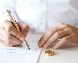 Man signing marriage contract, closeup
